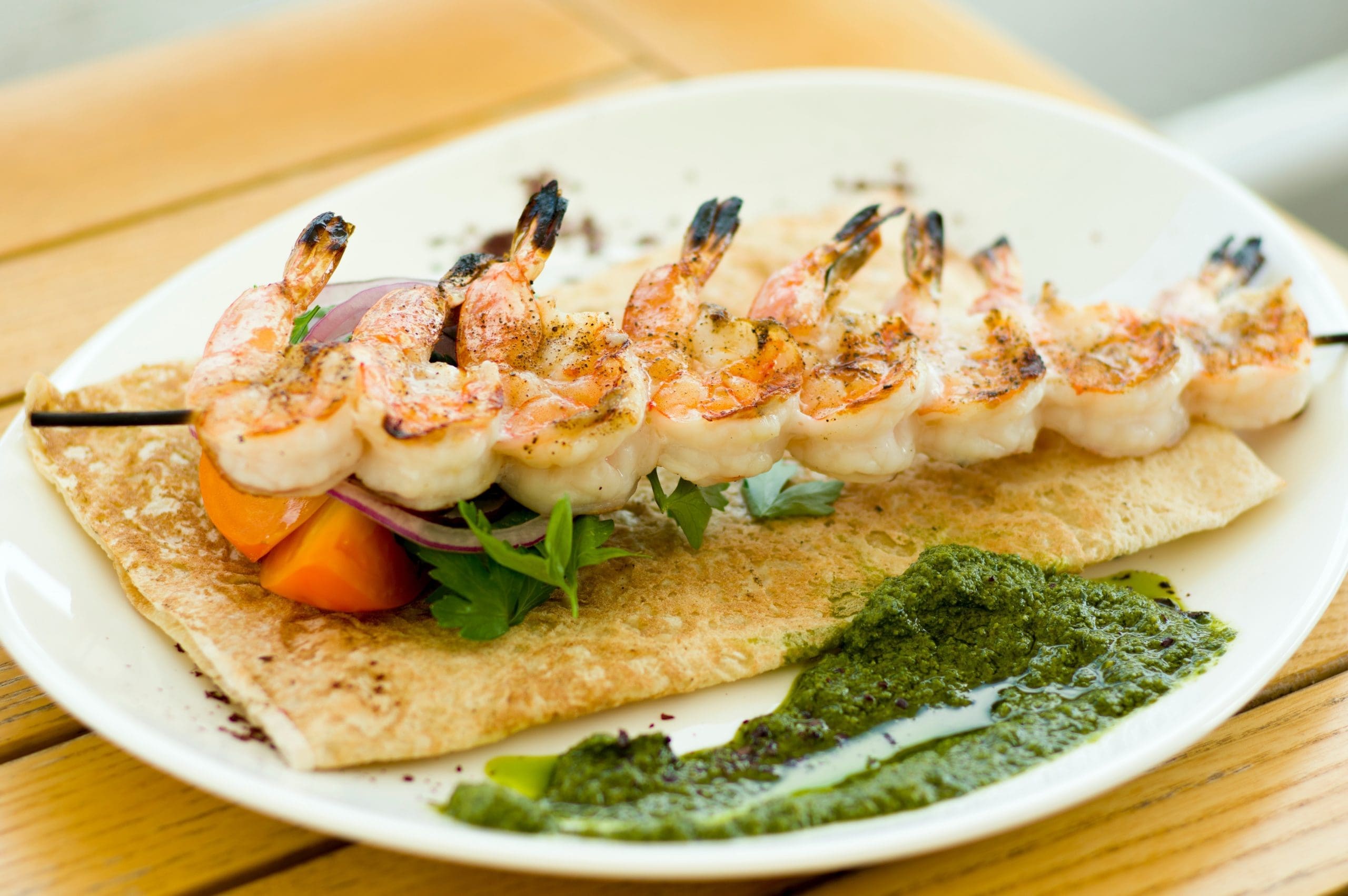 grilled shrimp on a skewer on a plate